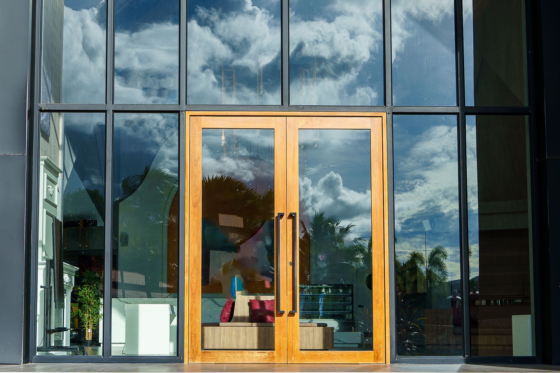 Glass entry doors with wood and steel trim outside of a commercial business
