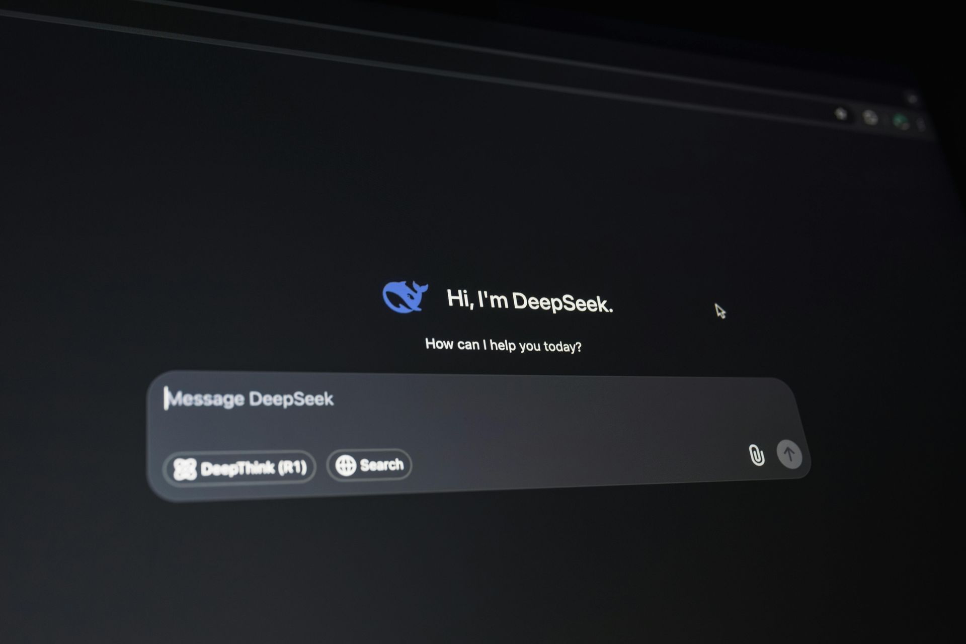 A dark-themed browser interface displaying the DeepSeek AI chat homepage with a prompt input field and logo.