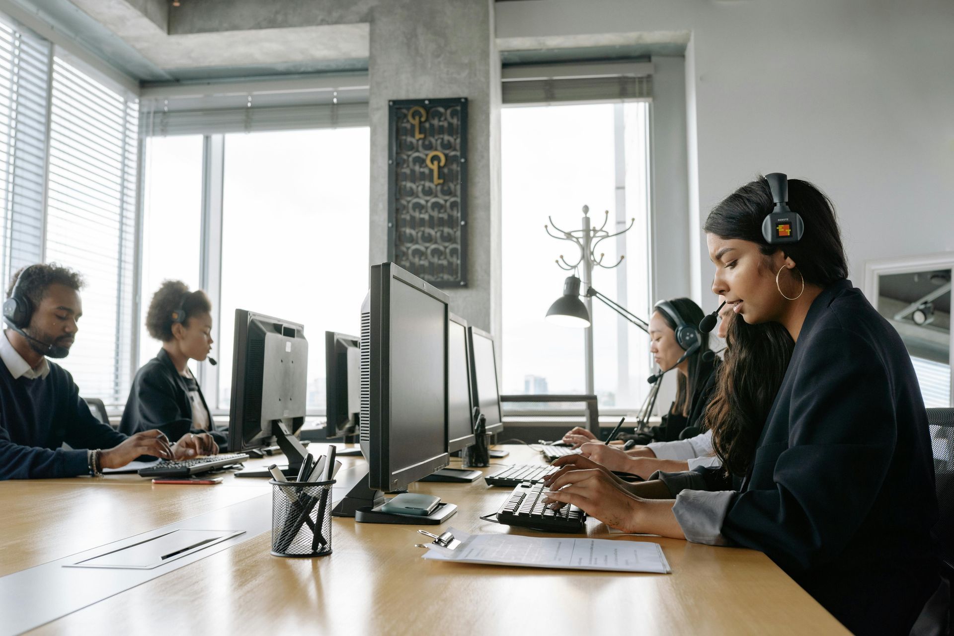 People working at computers in a bright modern office meeting room