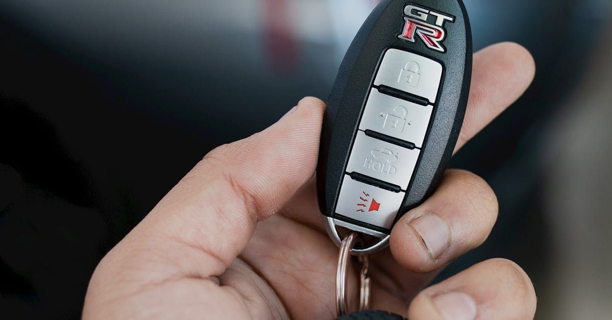 A person is holding a car key in their hand.