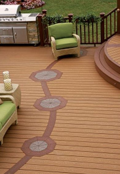 Wooden deck with a winding patterned inlay, green chairs, and a built-in grill area.