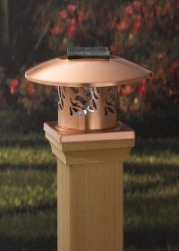 Outdoor lantern on a wooden post, with a beige cap and decorative cutout sides.