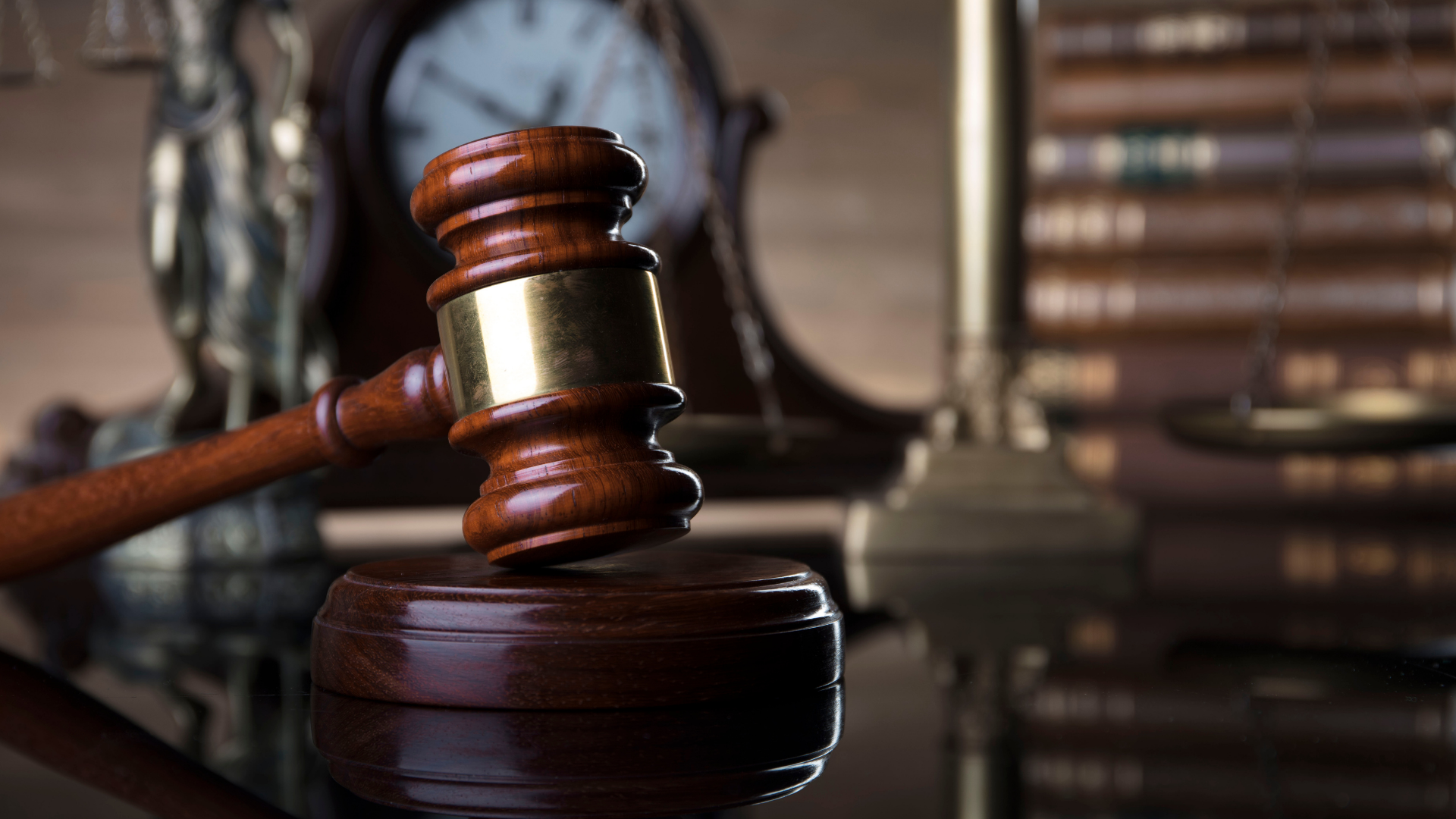 Judge’s gavel on a desk with law books in the background