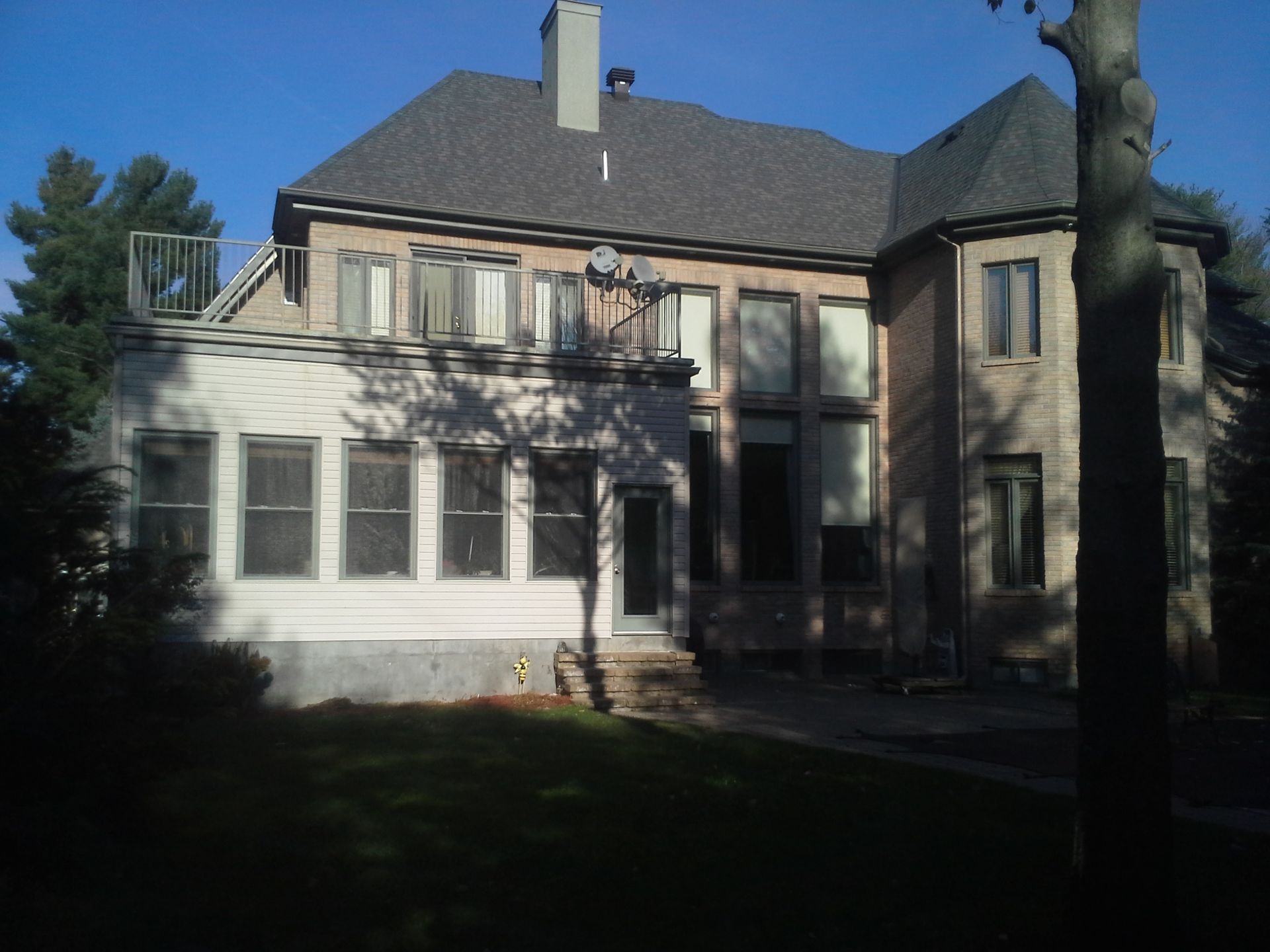 A large house with a gray roof and lots of windows
