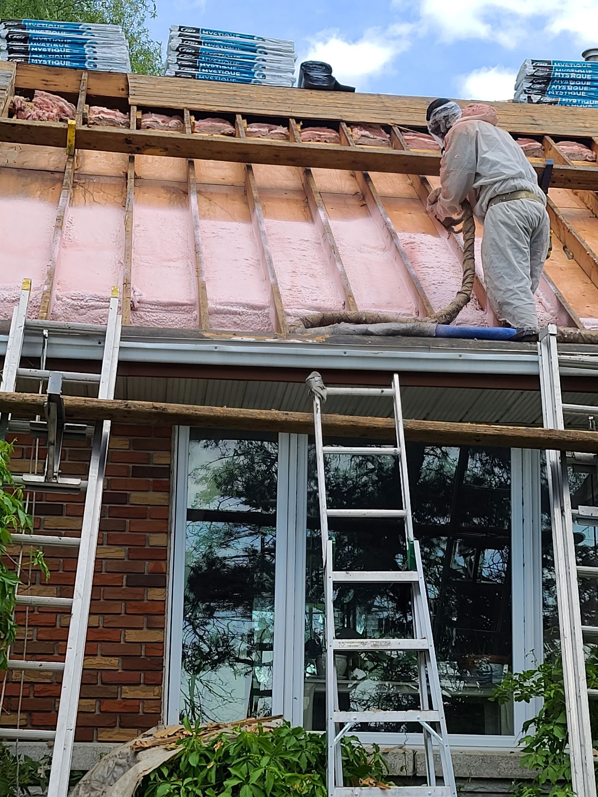 A man is working on the roof of a house