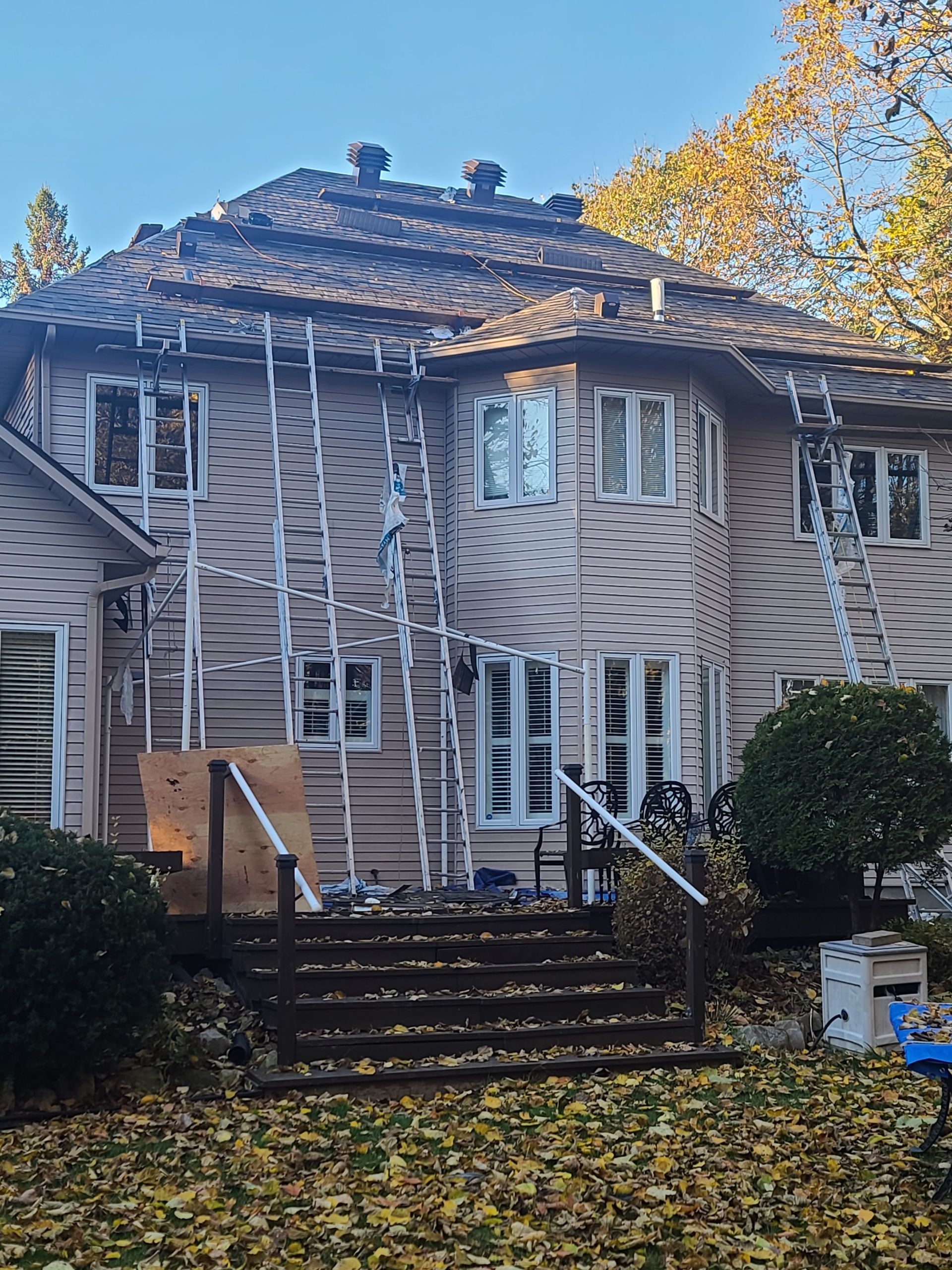 A large house with a roof that is being repaired.