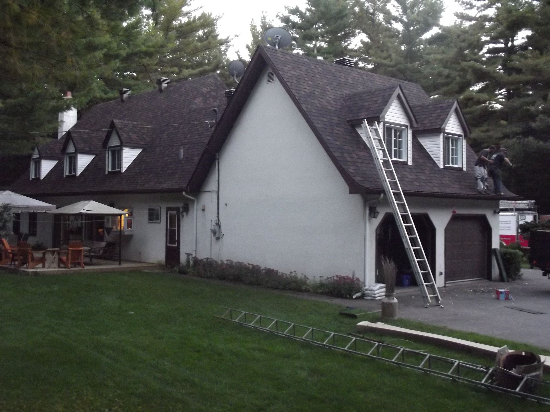 A white house with a ladder in front of it