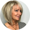 A woman with blonde hair is smiling in a circle.
