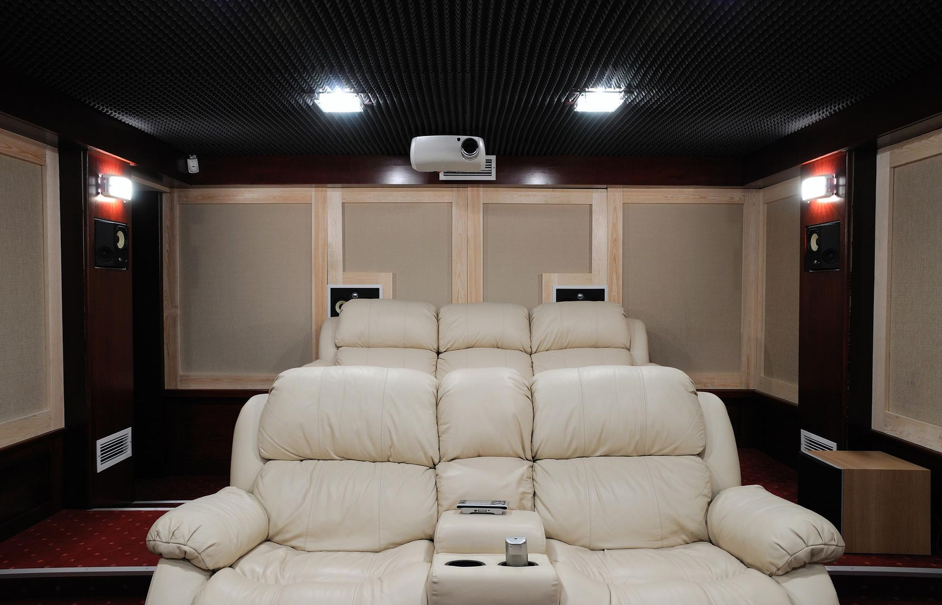 A home theater with a projector and a couch.