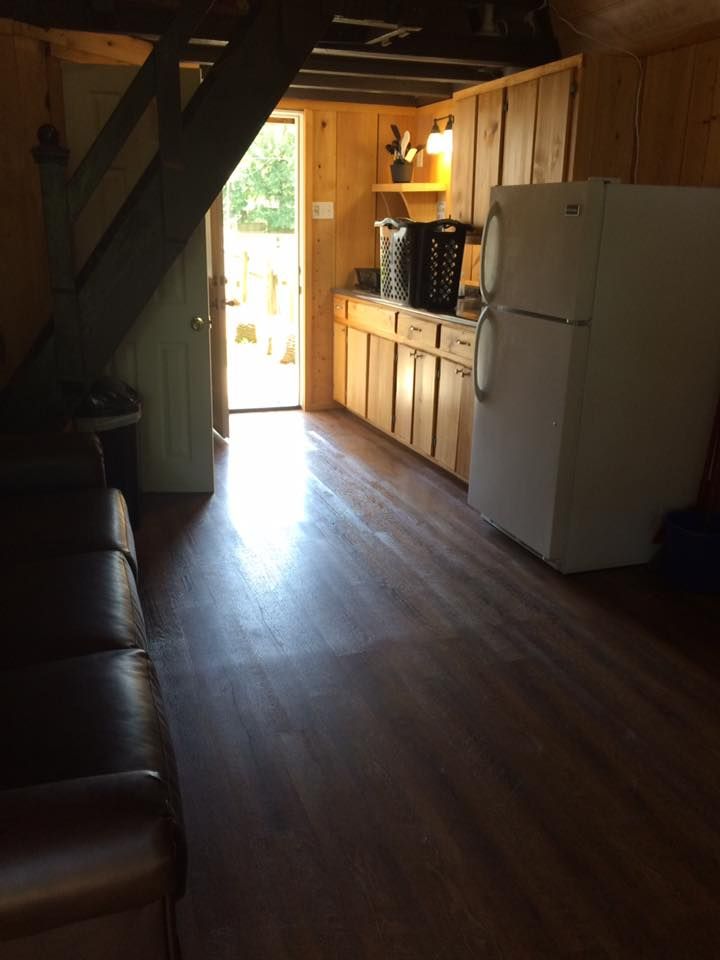 A kitchen with a white refrigerator and wooden cabinets