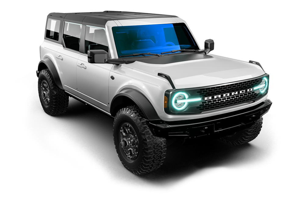 Silver off-road SUV with black roof and glowing blue headlights on a white background