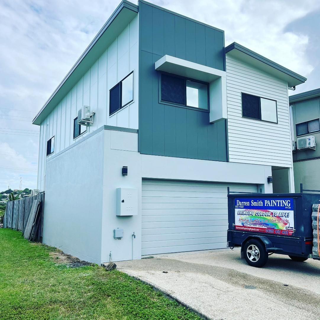 A Truck Is Parked in Front of A Large House — Darren Smith Painting Pty Ltd in Sarina, QLD