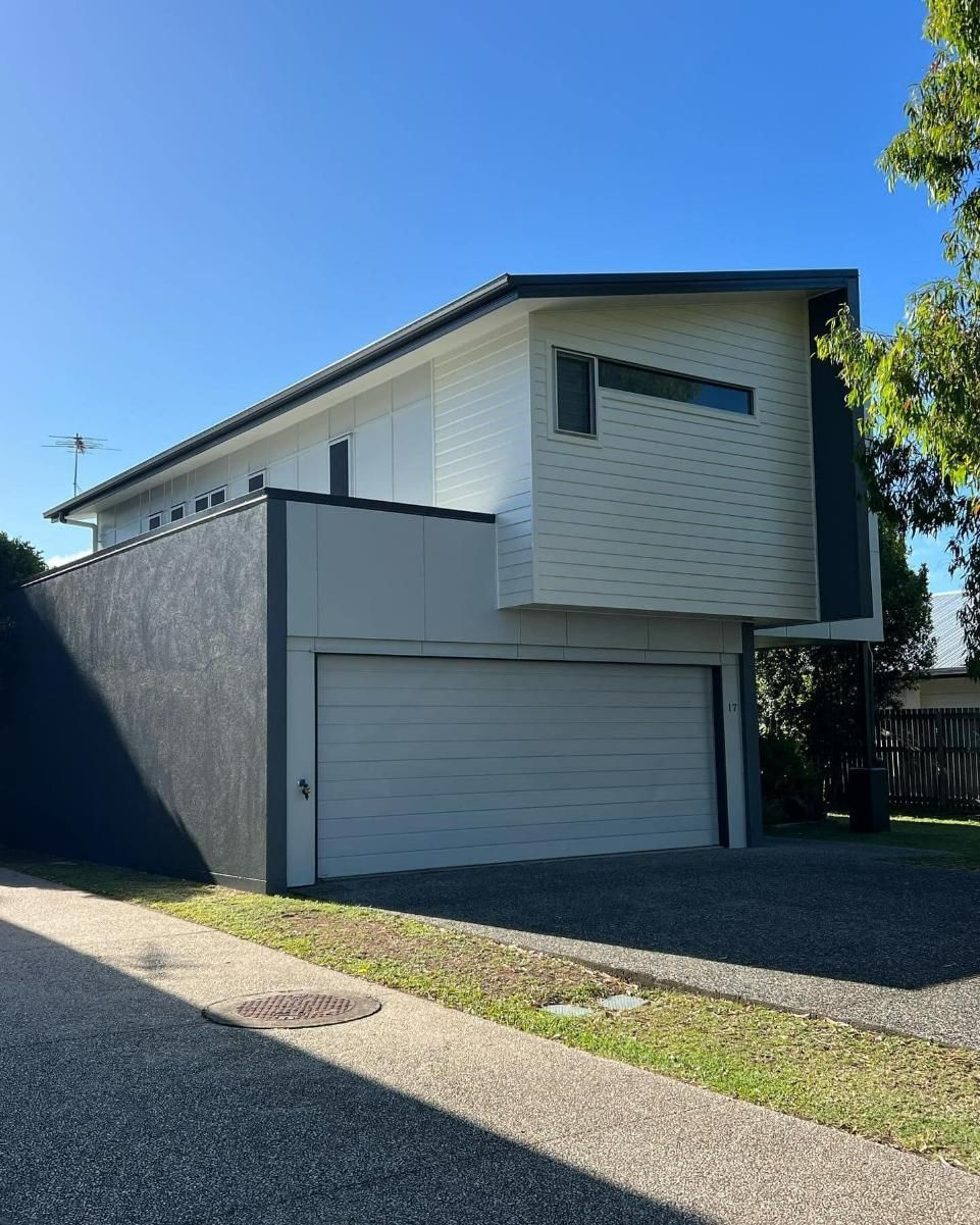 A White House with A Garage and A Blue Sky in The Background — Darren Smith Painting Pty Ltd in Sarina, QLD