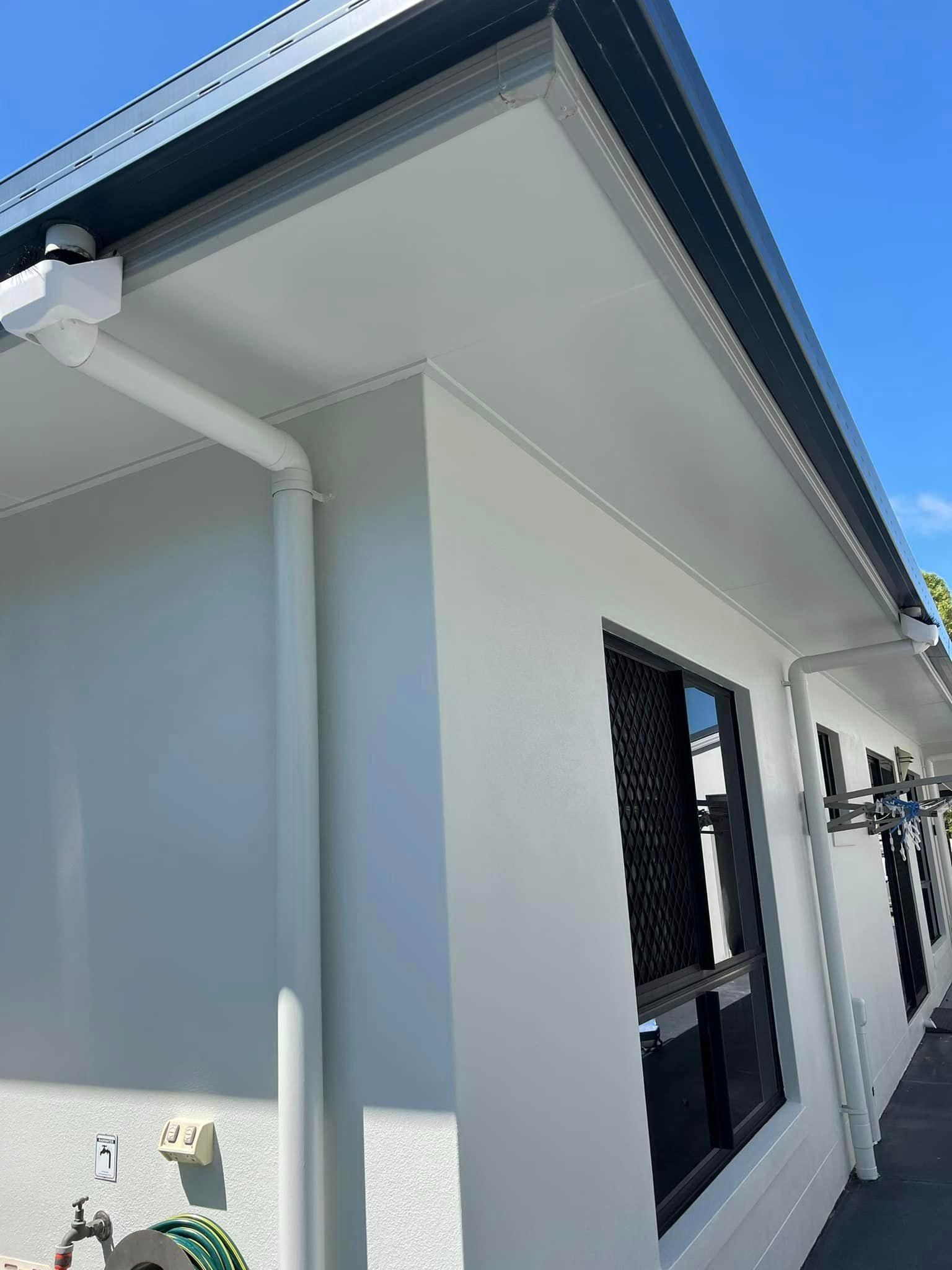 A White House with A Black Roof and Gutters — Darren Smith Painting Pty Ltd in Rural View, QLD