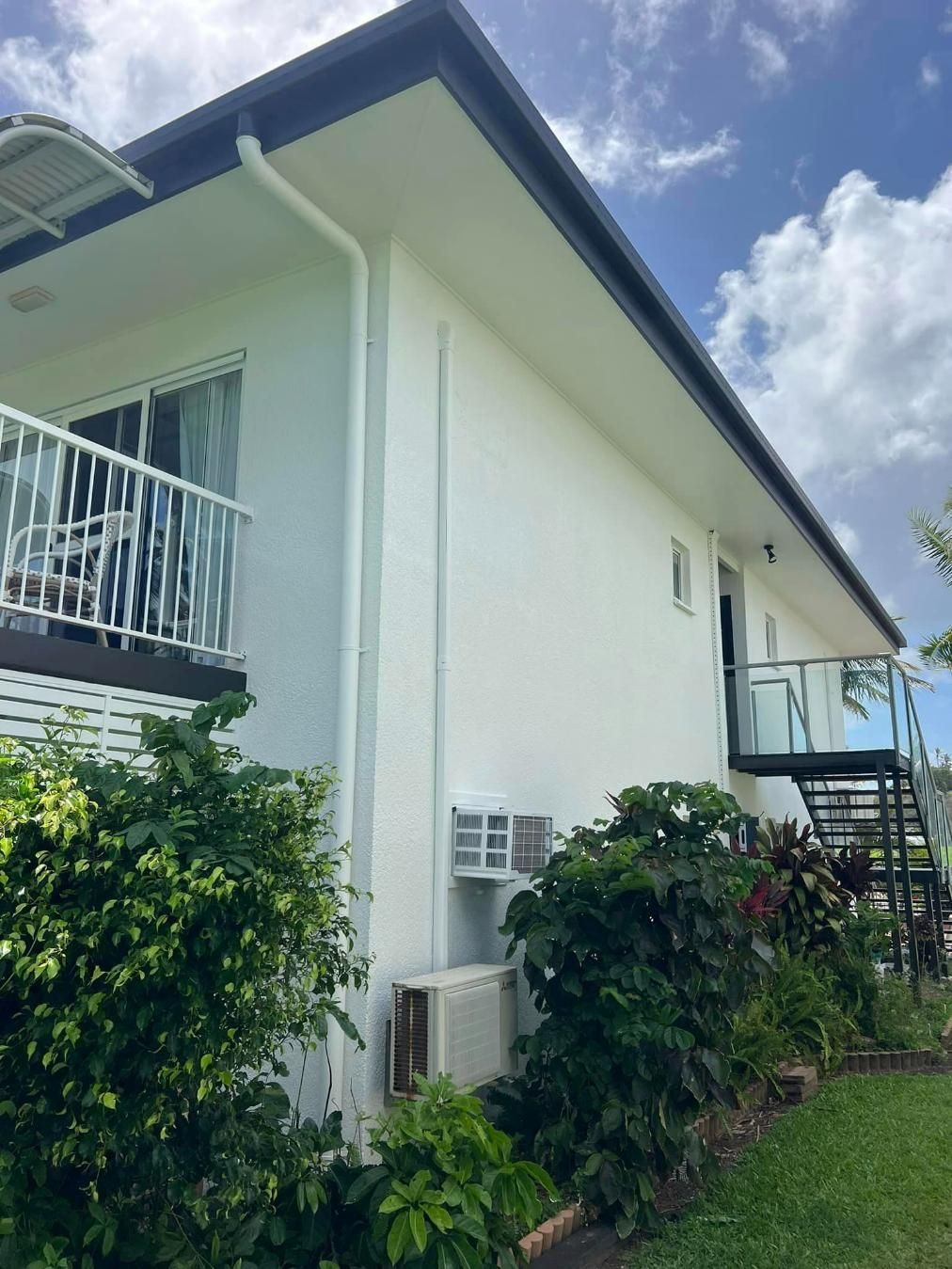 A White House with A Balcony and Stairs in The Backyard — Darren Smith Painting Pty Ltd in Sarina, QLD