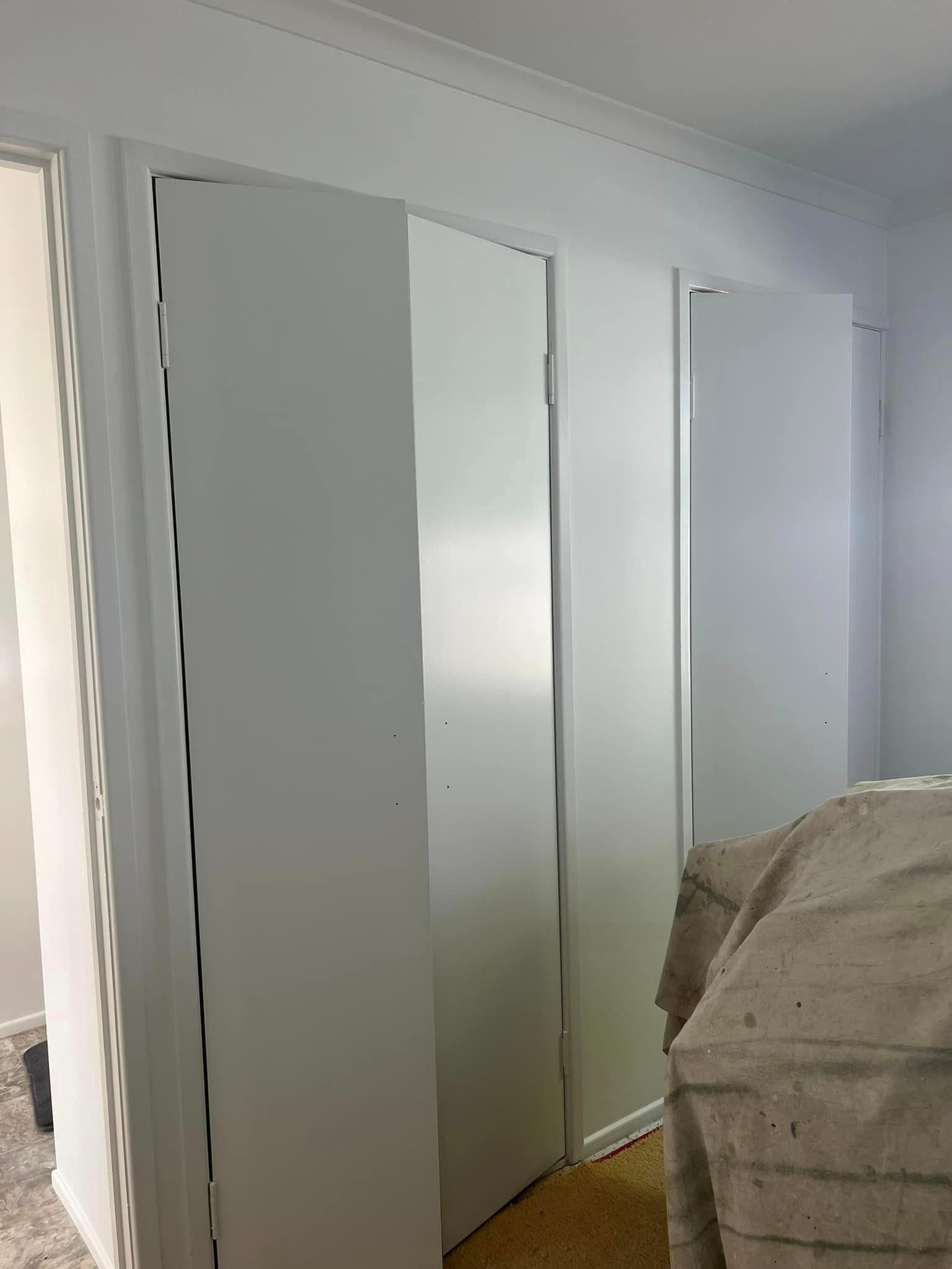 A Bedroom with White Walls , White Doors and A Bed — Darren Smith Painting Pty Ltd in Sarina, QLD