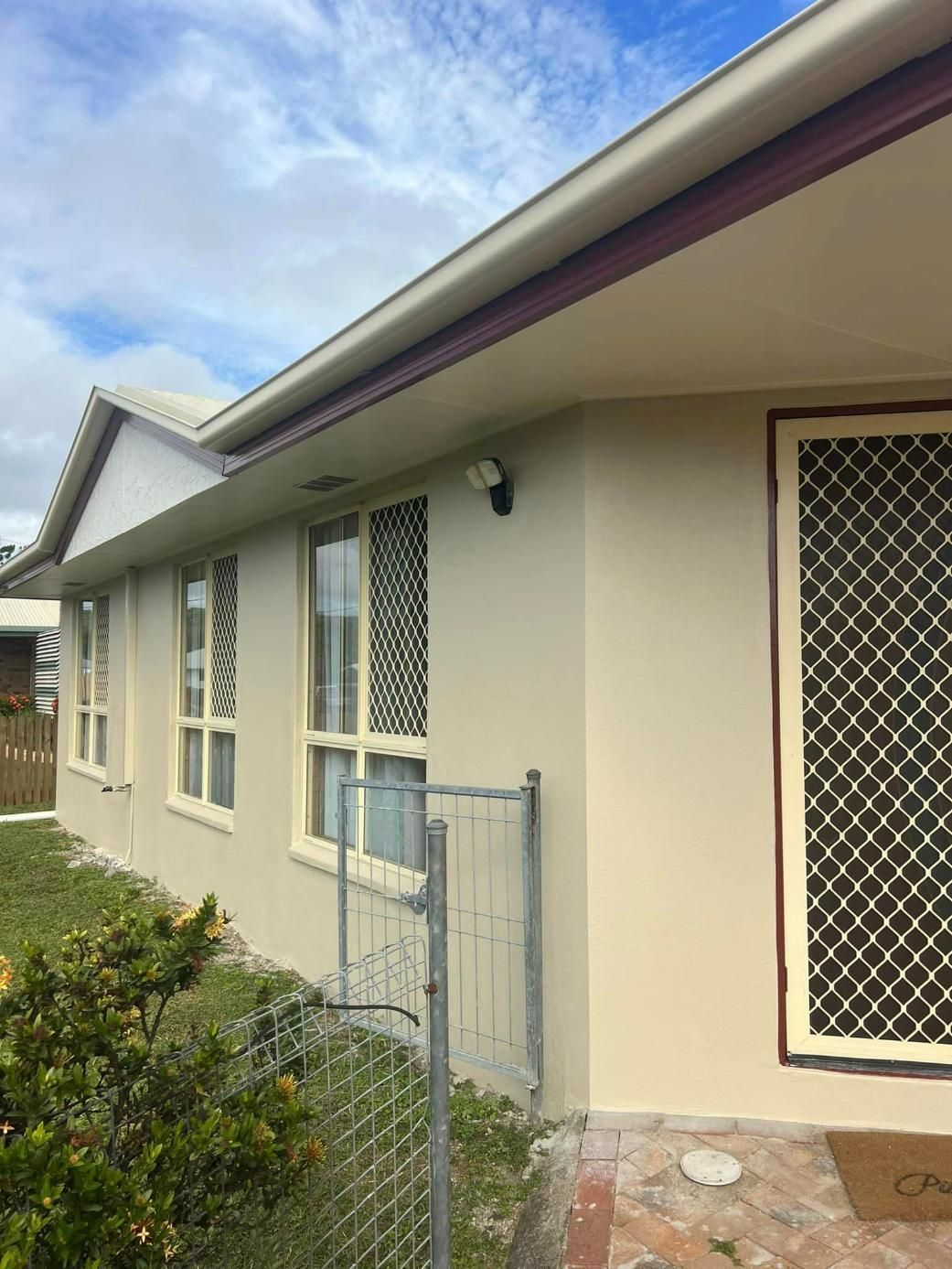 A White House with A Fence in Front of It — Darren Smith Painting Pty Ltd in Rural View, QLD