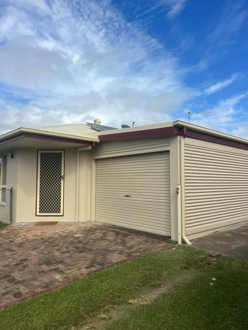 A White House with A Garage and A Blue Sky in The Background — Darren Smith Painting Pty Ltd in Rural View, QLD