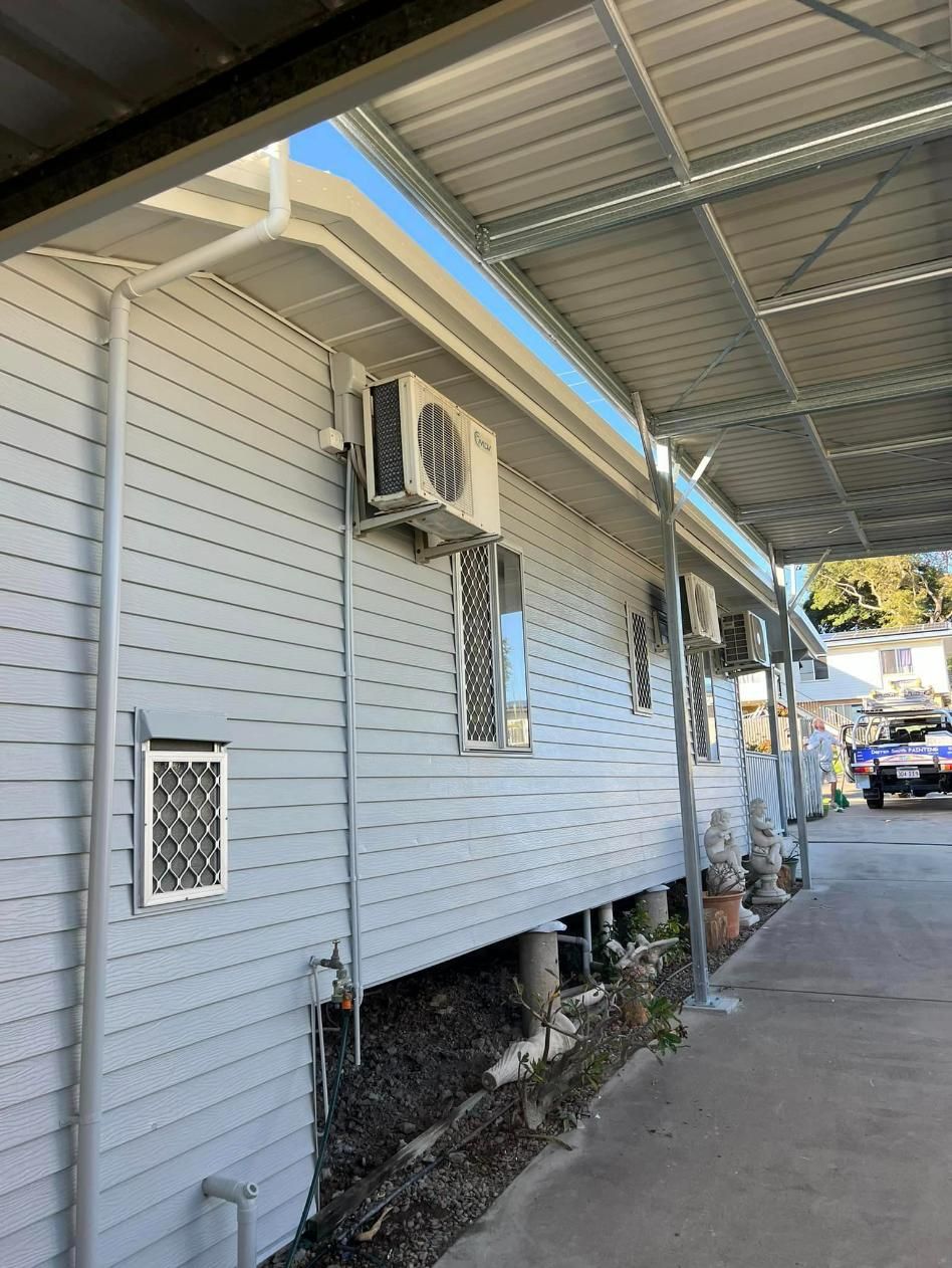 A House with A Covered Walkway and A Car Parked Underneath It — Darren Smith Painting Pty Ltd in Rural View, QLD