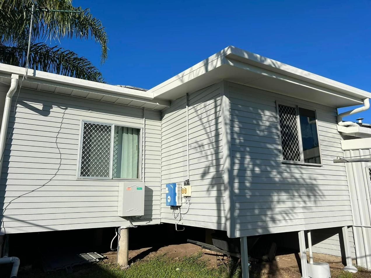 A White House with A Blue Sky in The Background — Darren Smith Painting Pty Ltd in Rural View, QLD