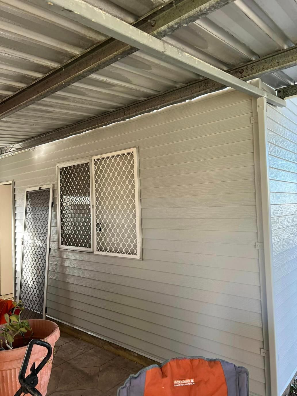 A White House with A Metal Roof and Two Windows — Darren Smith Painting Pty Ltd in Rural View, QLD