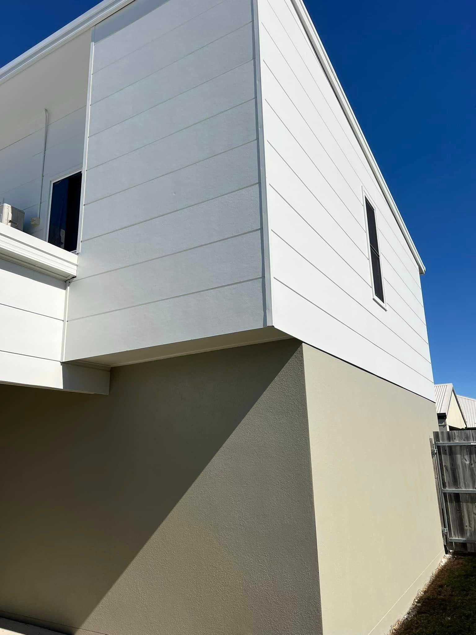 A White House with A Blue Sky in The Background — Darren Smith Painting Pty Ltd in Rural View, QLD