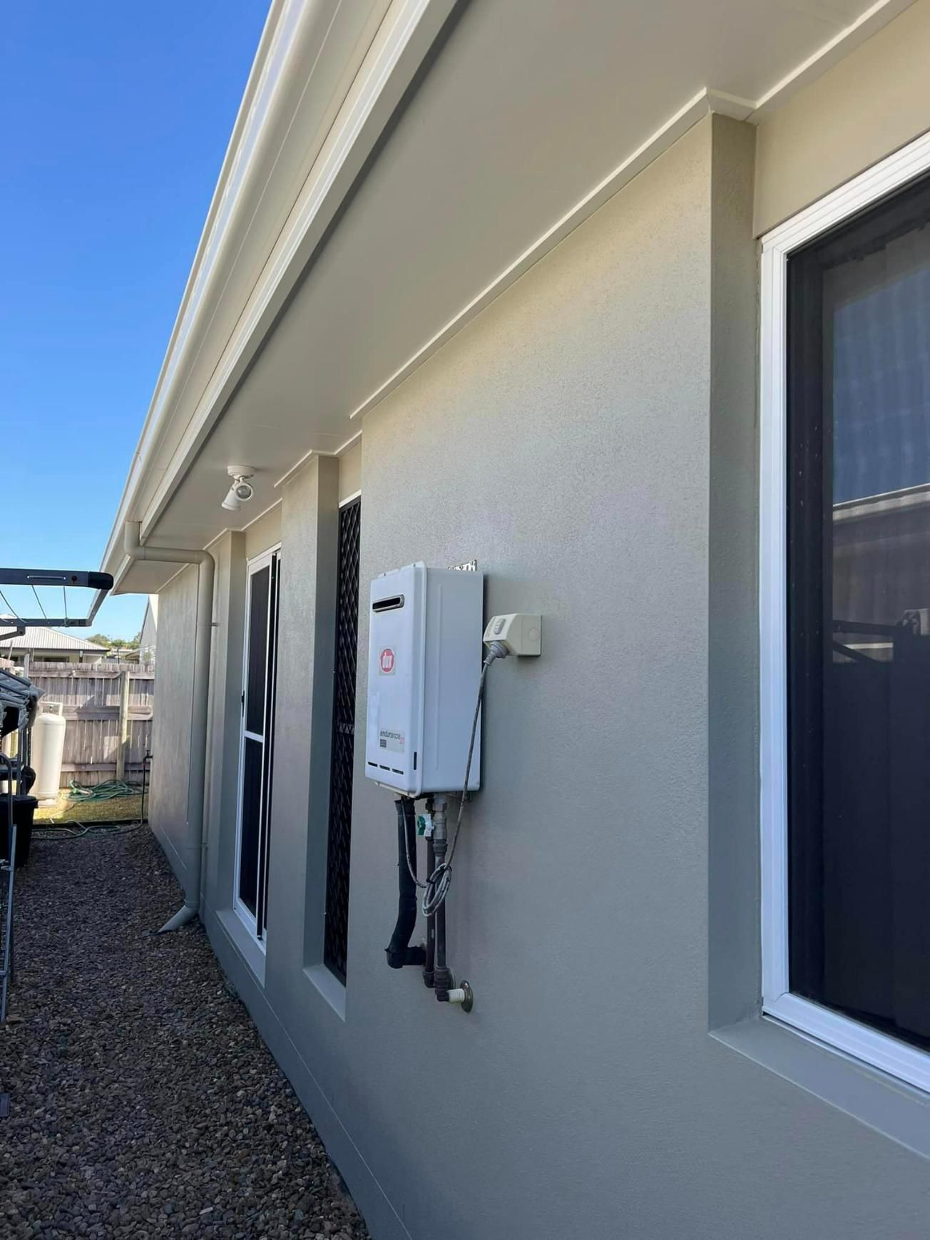 A House with A Water Heater on The Side of It — Darren Smith Painting Pty Ltd in Rural View, QLD