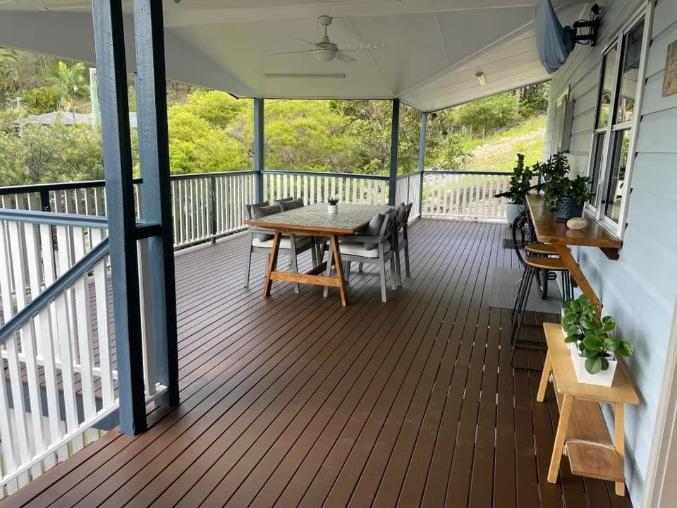 A Large Deck with A Table and Chairs on It — Darren Smith Painting Pty Ltd in Sarina, QLD