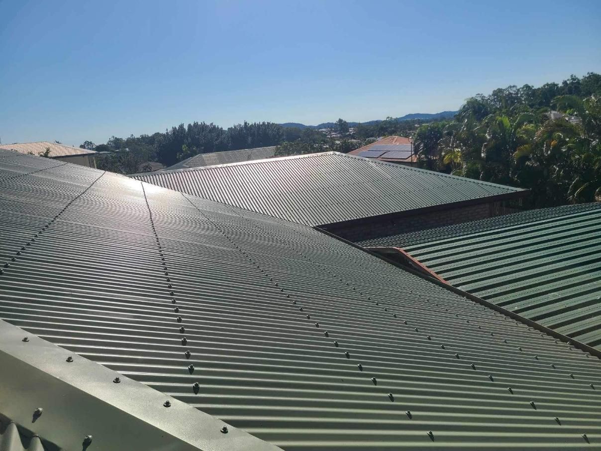 A Roof of A Building with A Blue Sky in The Background — Darren Smith Painting Pty Ltd in Mackay, QLD