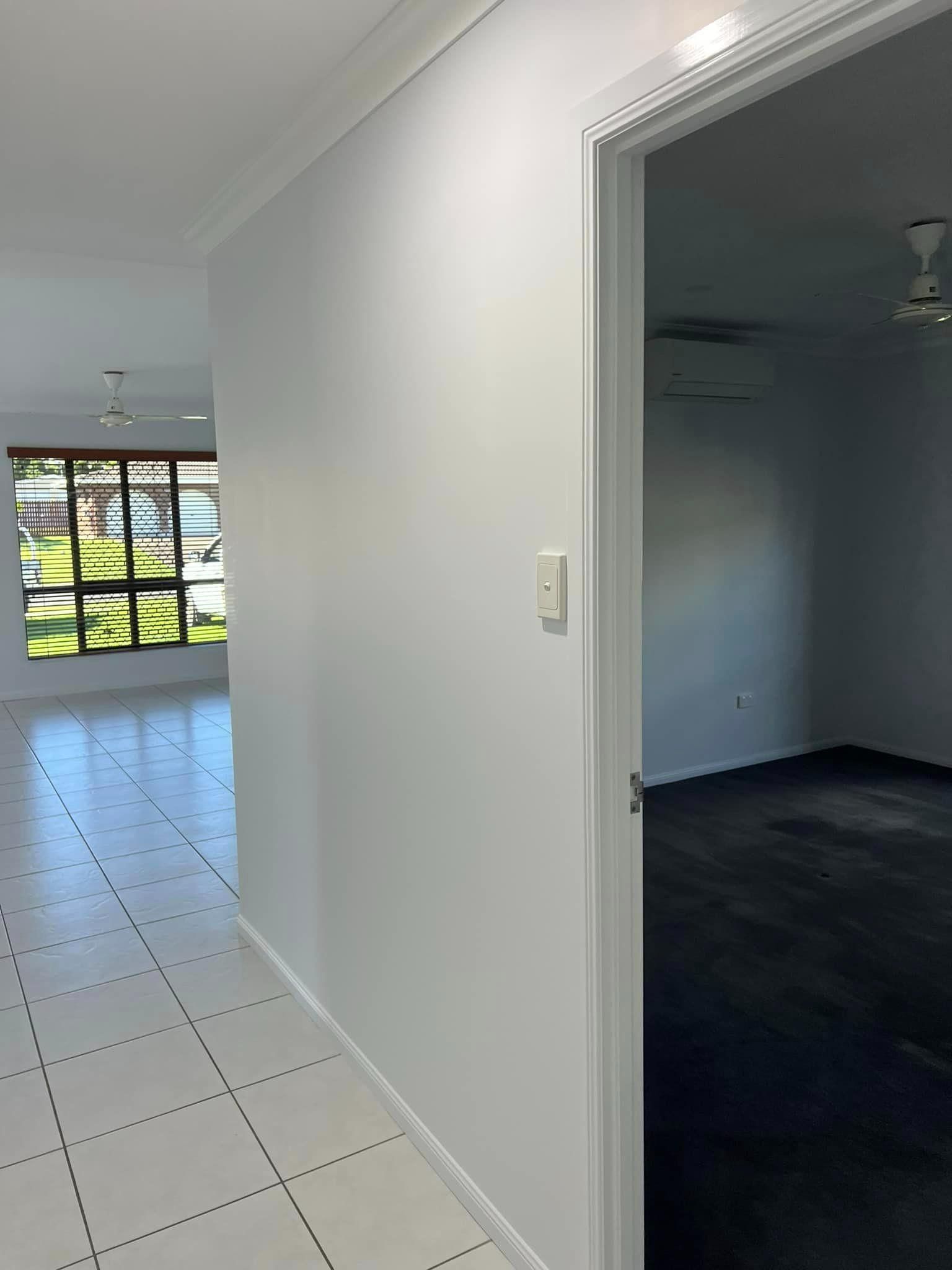 A Hallway in A House with A Door Open Leading to A Bedroom — Darren Smith Painting Pty Ltd in Rural View, QLD