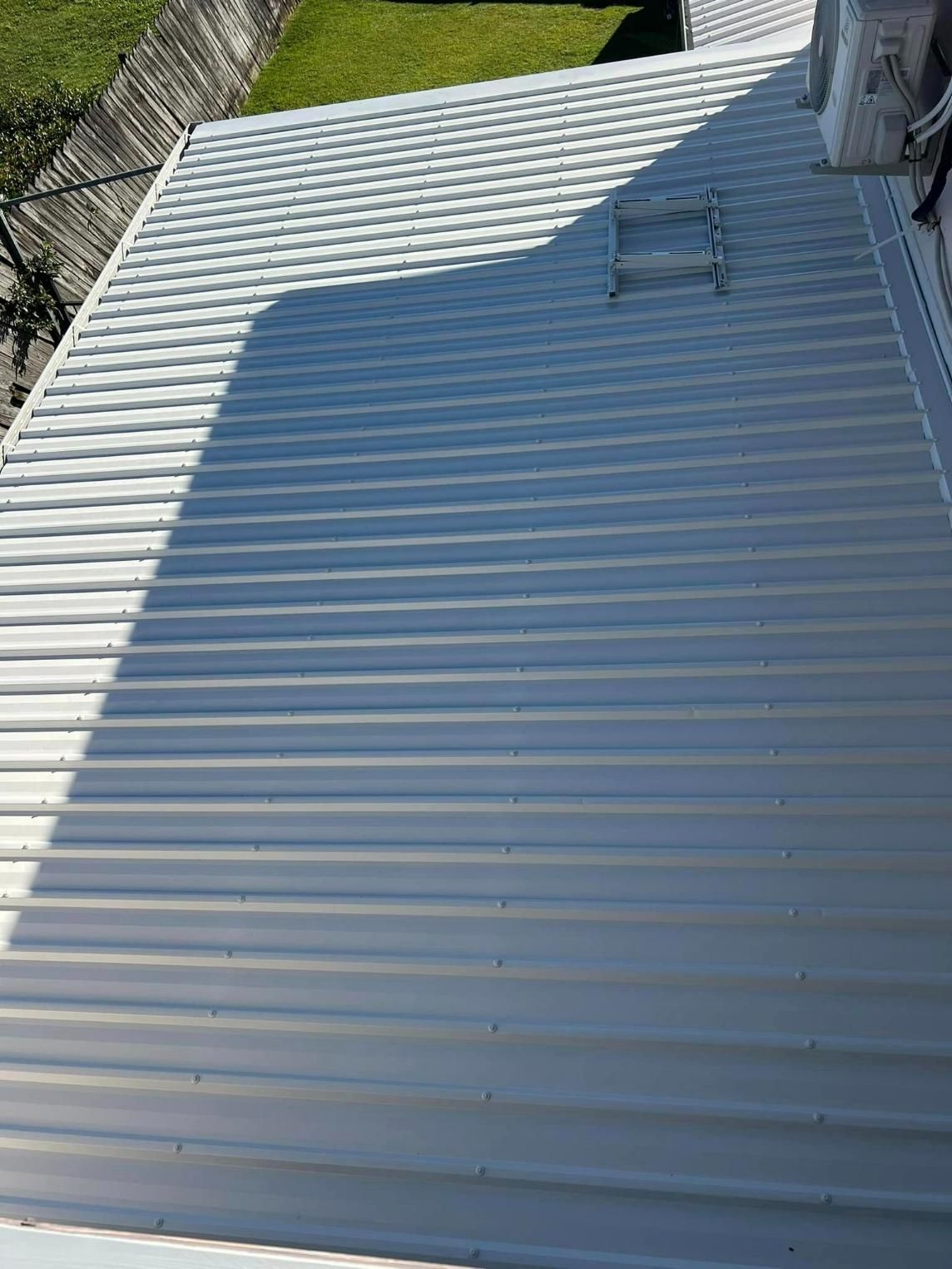 A White Metal Roof with A Ladder on Top of It — Darren Smith Painting Pty Ltd in Rural View, QLD