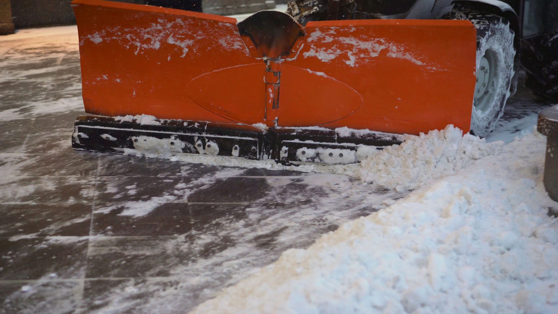 Snowplow truck clearing snow from a road on a sunny day. Snowplow truck clearing snow from a road on a sunny day.