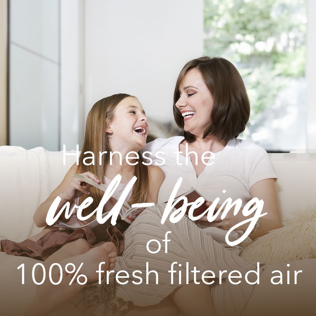 A woman and a child are sitting on a couch with the words harness the well-being of 100 % fresh filtered air