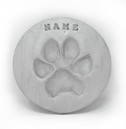 a picture of a puppy and a paw print in a frame .