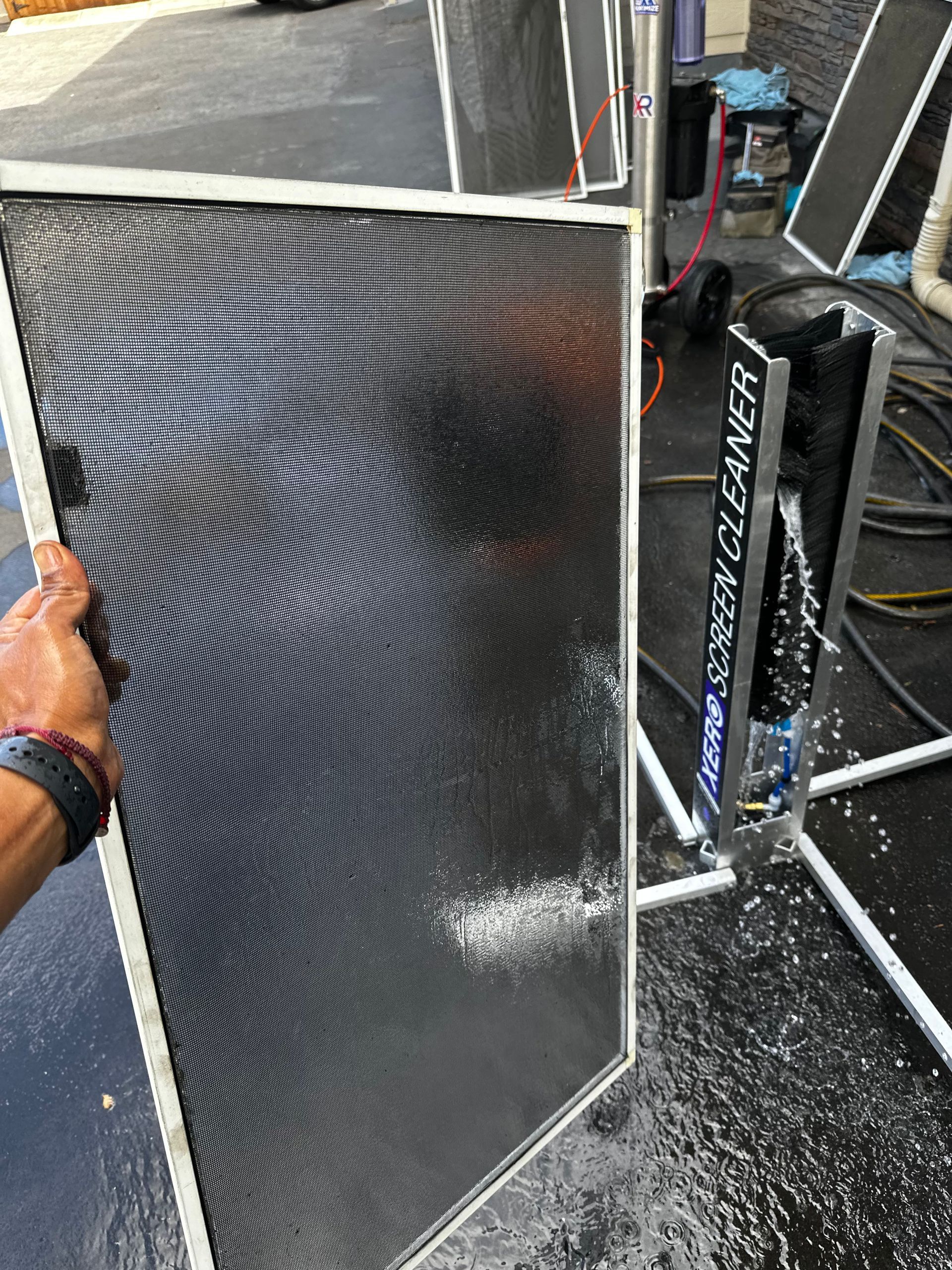 Person cleaning a screen with a 