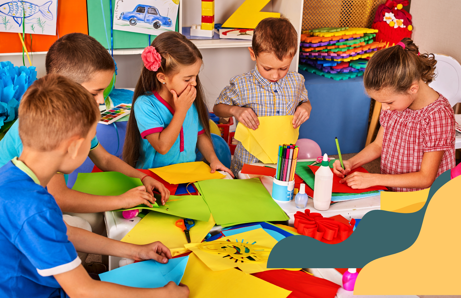 A group of children are sitting around a table making crafts.