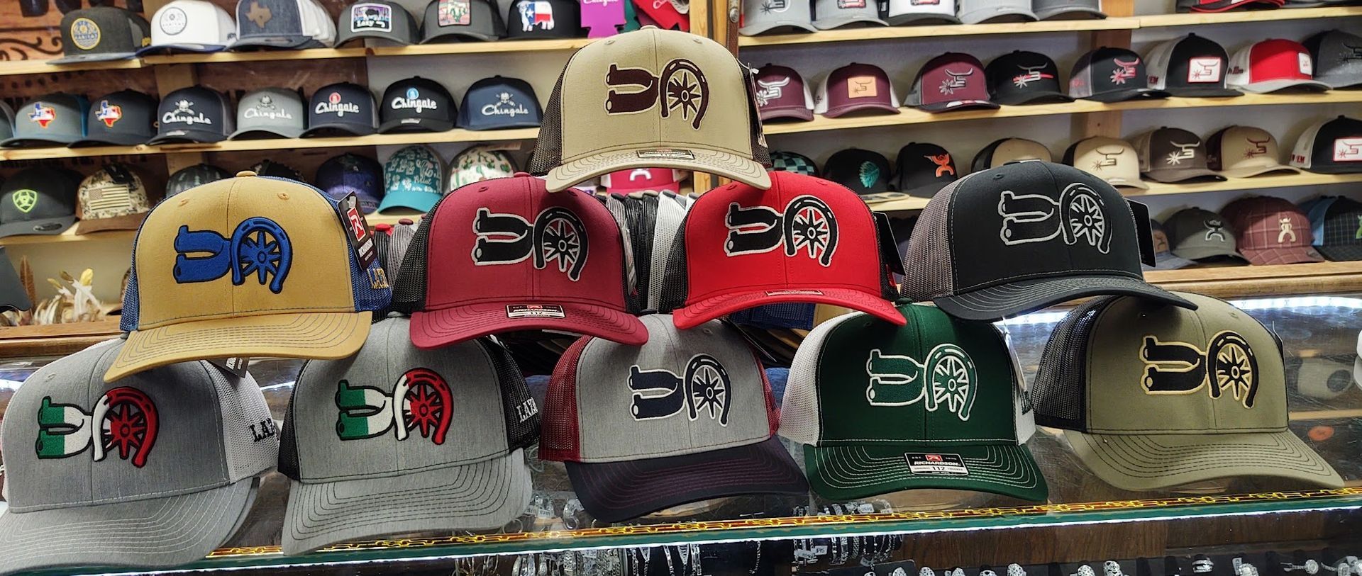 Display of colorful caps with decorative butterfly logos on shelves in a shop
