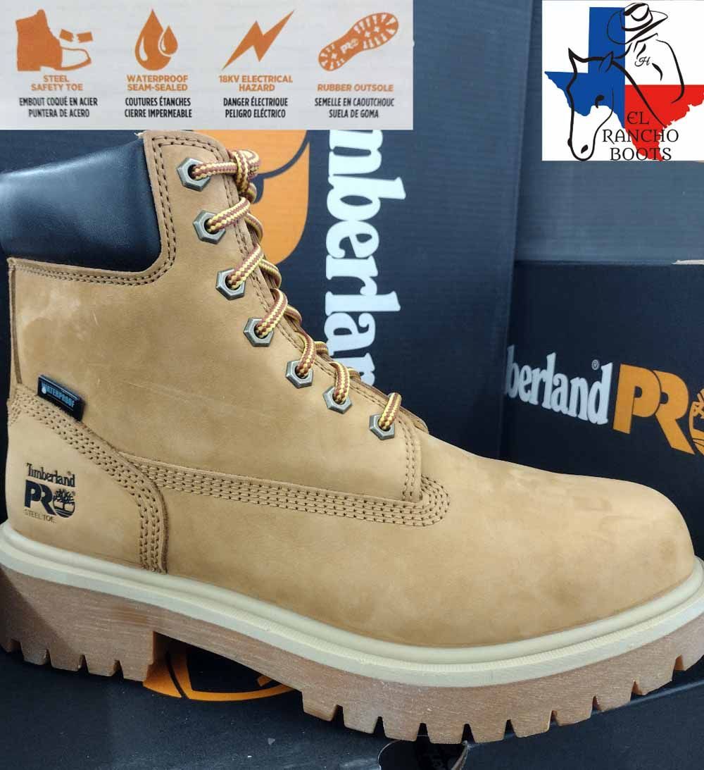 Tan suede work boot with tan sole and navy collar, displayed in front of Timberland Pro boxes