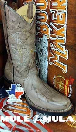 Tan cowboy boot on a MULA MULA package, with white leather and stitched detailing.
