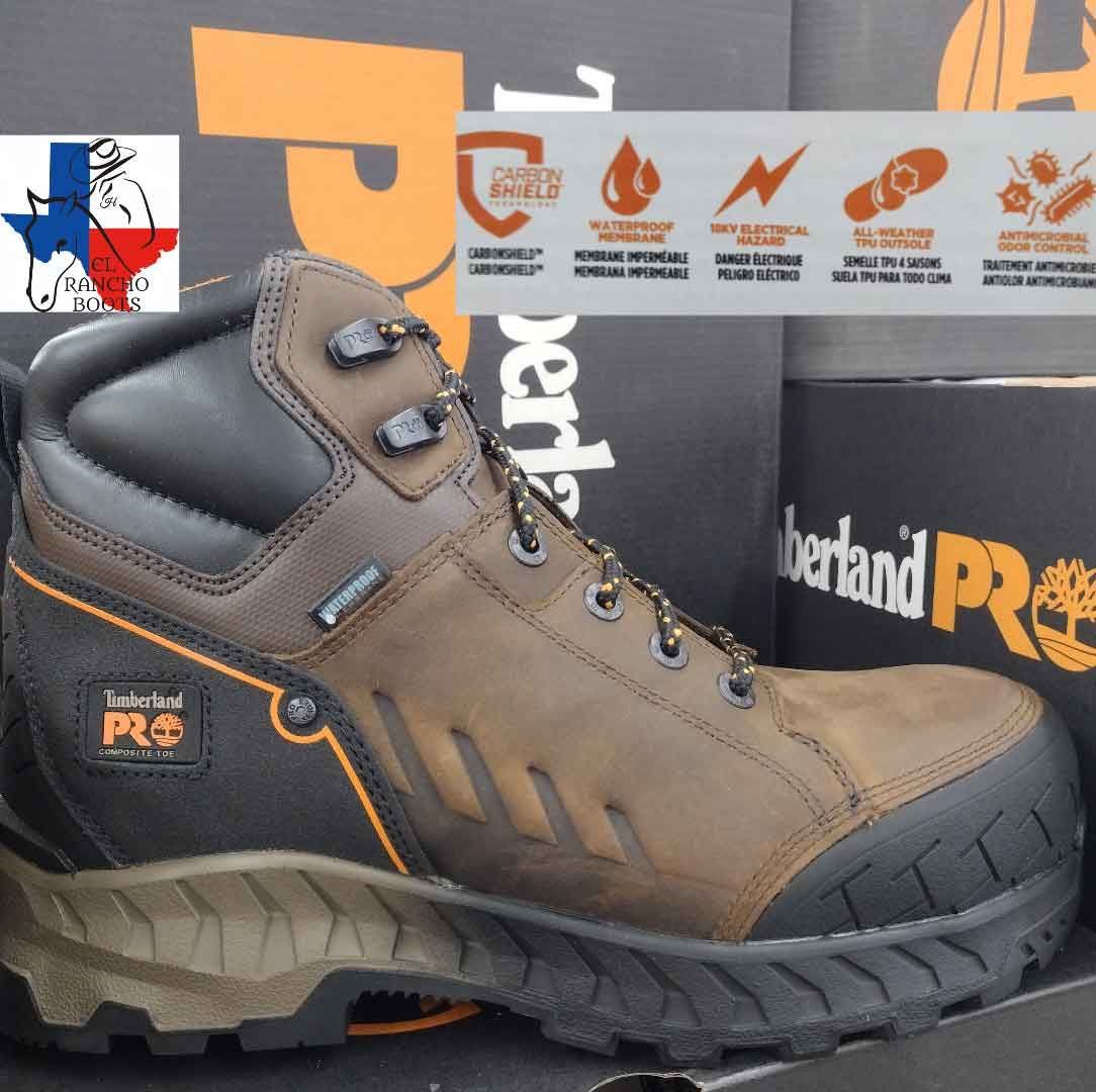 Brown and black Timberland PRO work boot with orange accents on a branded background