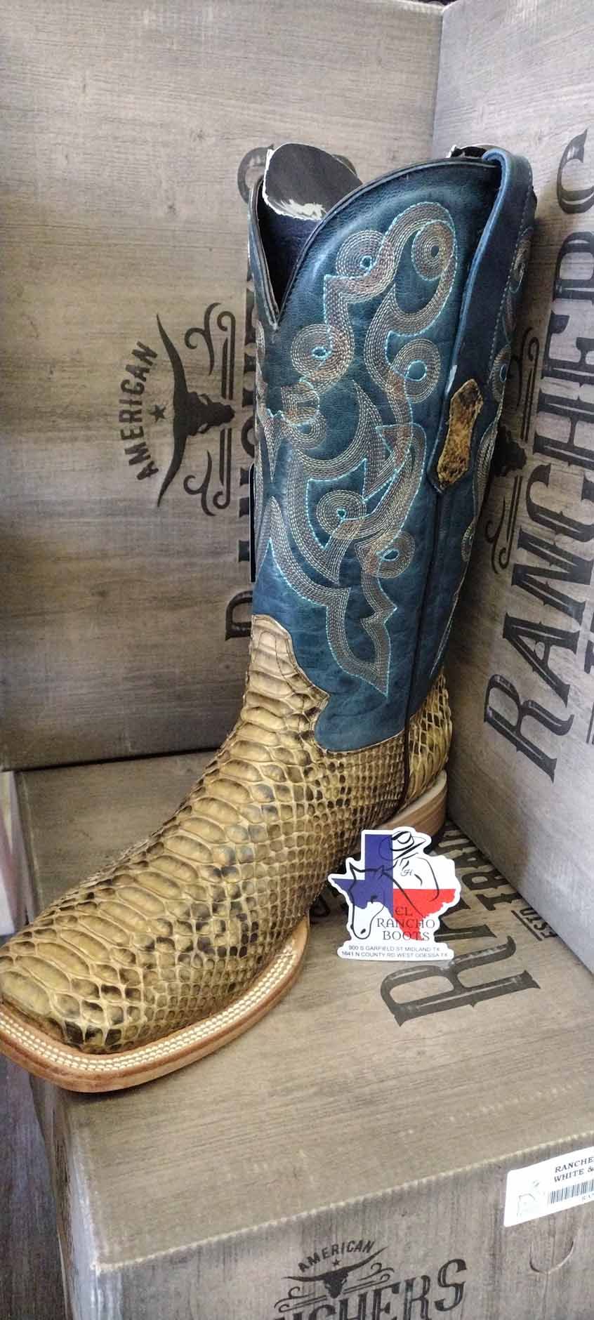 Blue and tan cowboy boot with ornate stitching displayed on a store shelf