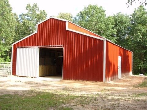 Red steel building with big white door