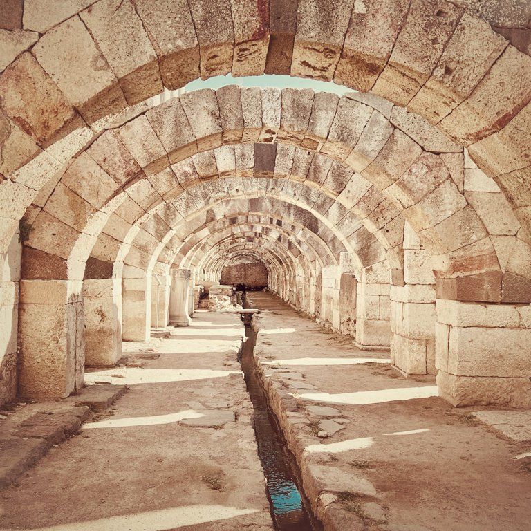 water trench and rounded arches in underground ancient ruins of Smyrna, Izmir, Turkey