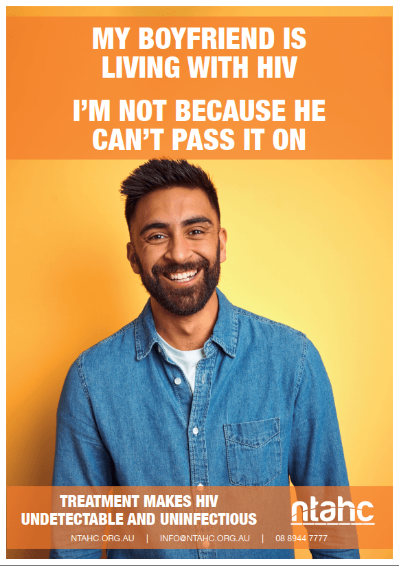 A man with a beard is smiling on a yellow background.