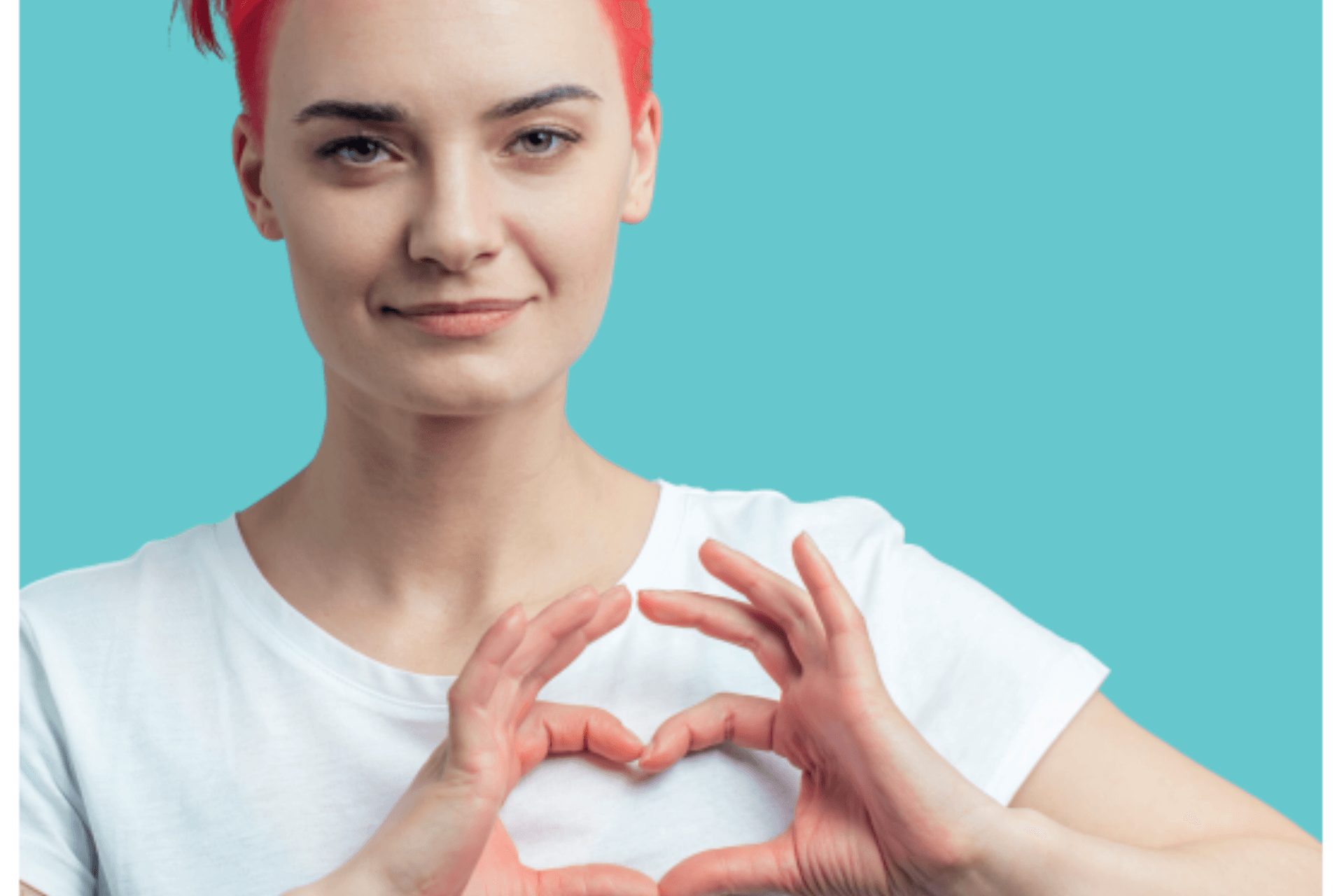 A woman with red hair is making a heart shape with her hands.