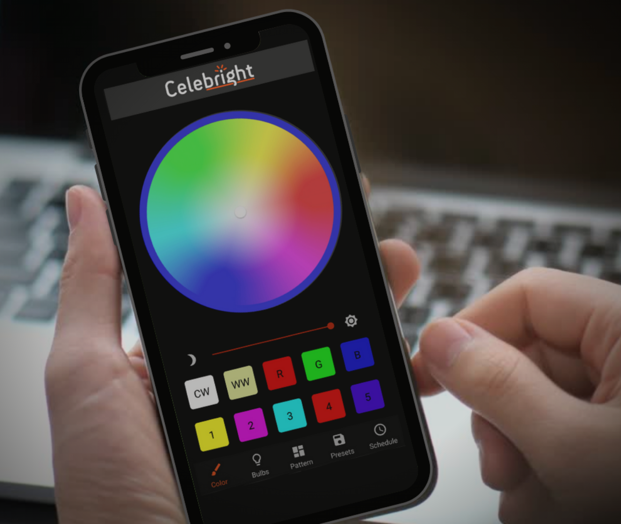 A person is holding a cell phone that says celebright on the screen