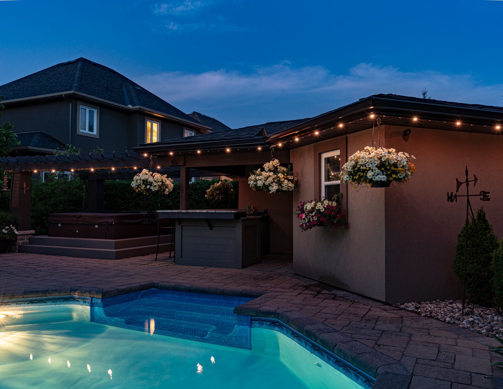 Celebright permanent lighting providing accent illumination around a pool.