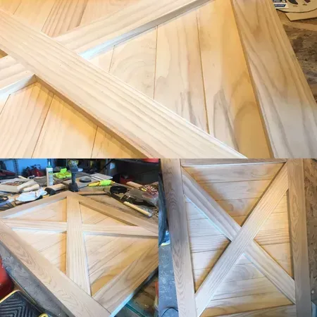 Wooden door with an X design, light-colored wood, in various stages of construction, workshop setting.