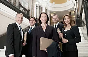 A group of business people are standing next to each other on a set of stairs.