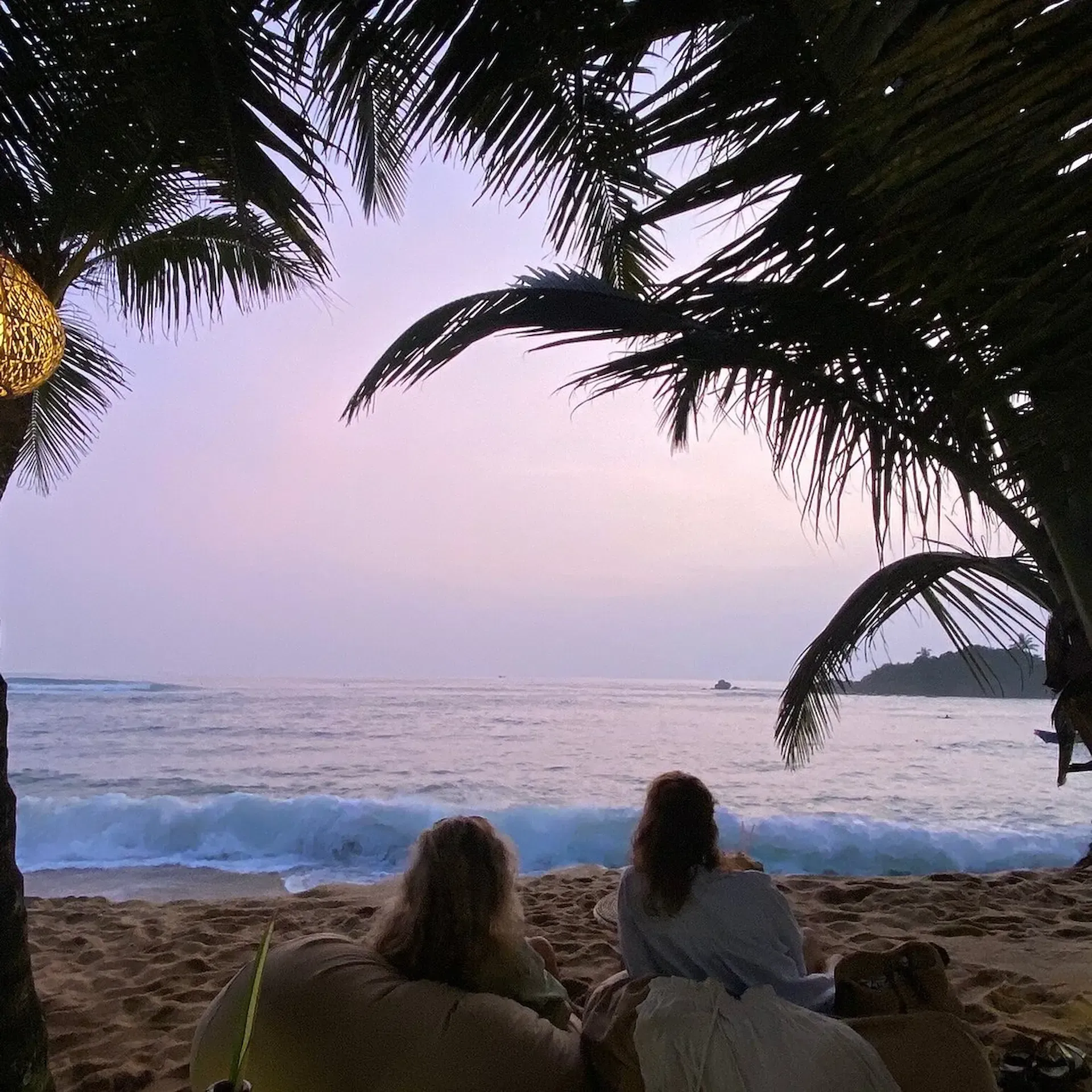 Travelers-relaxing-on-Mirissa-Beach-southern-coast-Sri-Lanka.